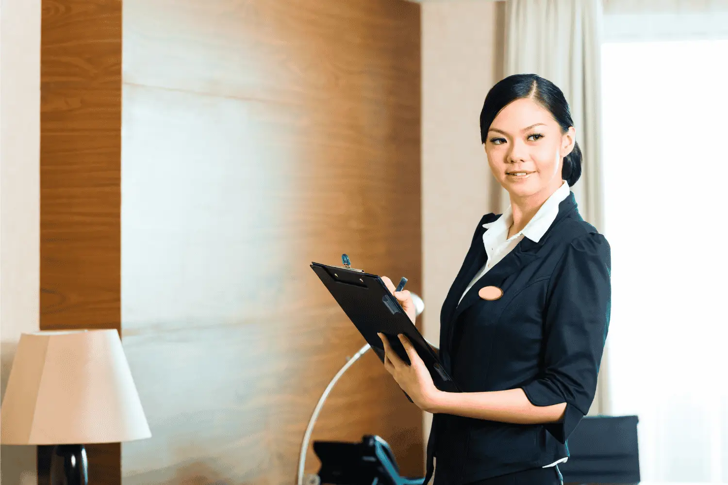 A person checking off items on an Hotel IT Solutions Checklist