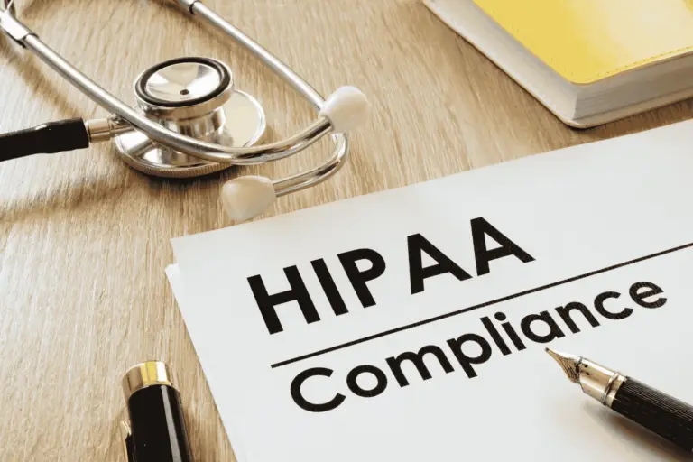 Doctor’s desk with a clipboard and stethescope displaying “HIPAA Compliance” text, representing the importance of a HIPAA risk assessment.