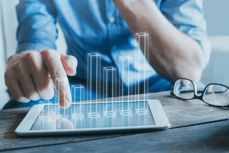 Business leader reviewing IT ROI on a tablet with a rising performance graph.
