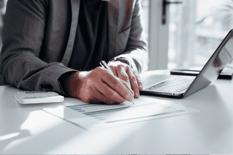 Financial professional working at a computer supported by IT services for business.
