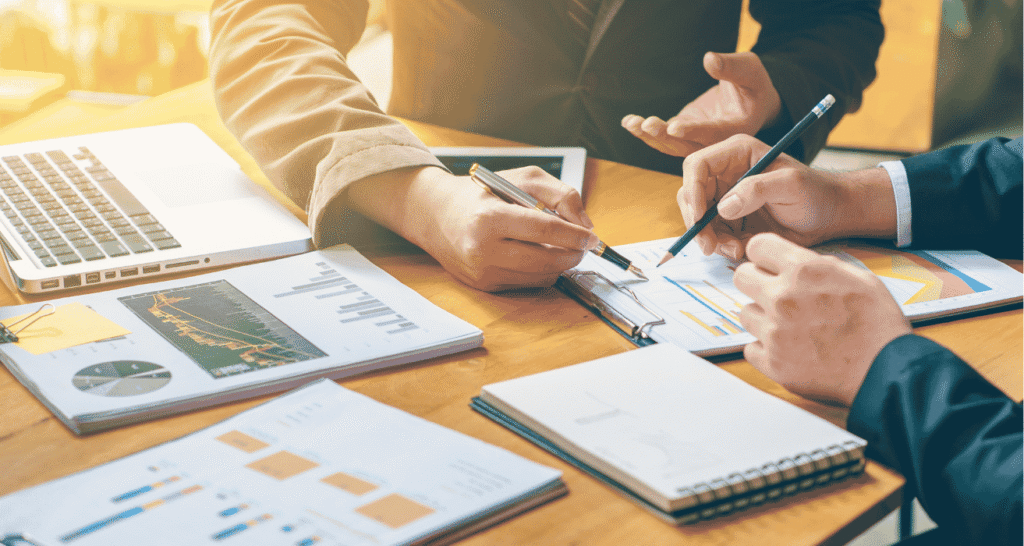 Desk with detailed graphs and data reports, illustrating insights used in strategic IT management