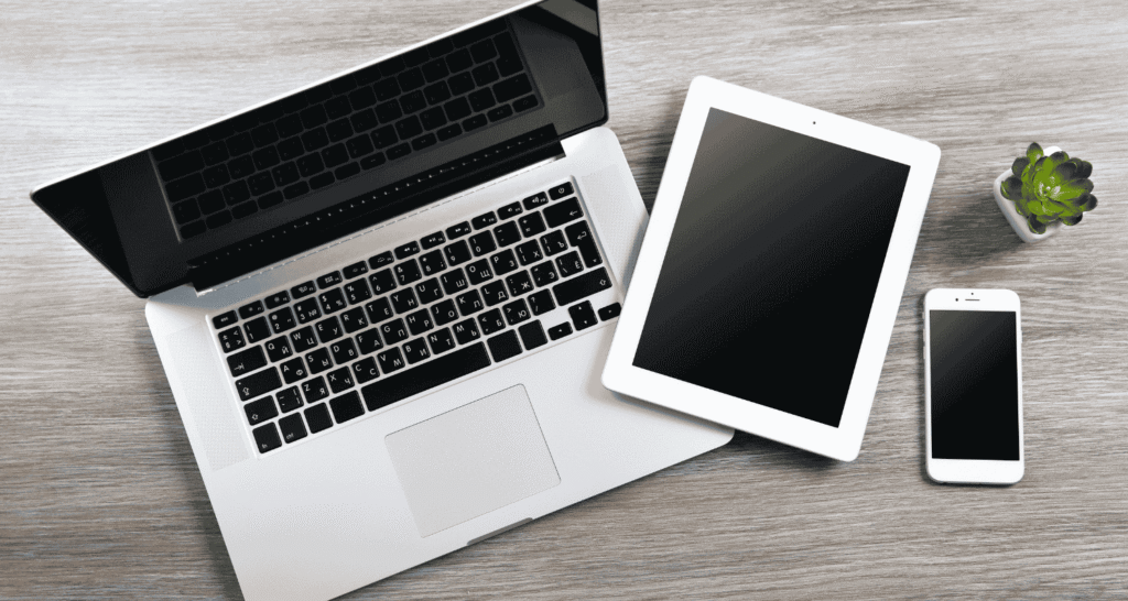 Business technology setup featuring a desktop computer, tablet, and smartphone, representing modern connectivity and strategic IT sourcing for businesses.