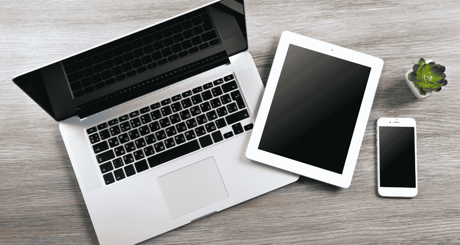 Business technology setup featuring a desktop computer, tablet, and smartphone, representing modern connectivity and strategic IT sourcing for businesses.