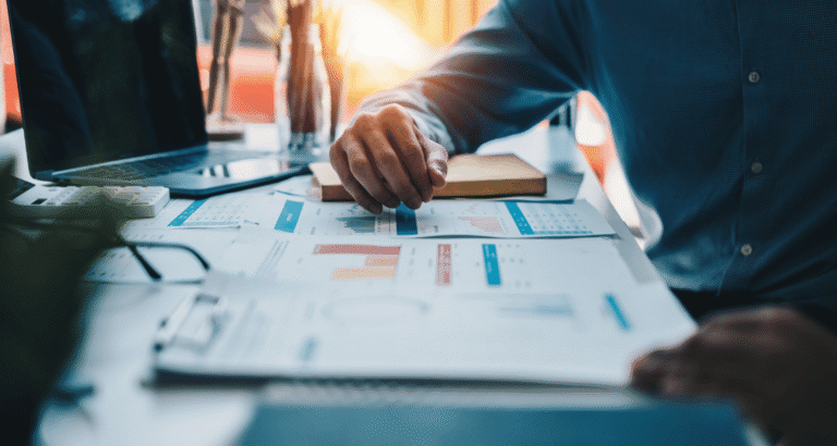 Compliance-ready business professional reviewing cybersecurity analytics and compliance dashboard on a computer to monitor risk, security controls, and regulatory readiness.